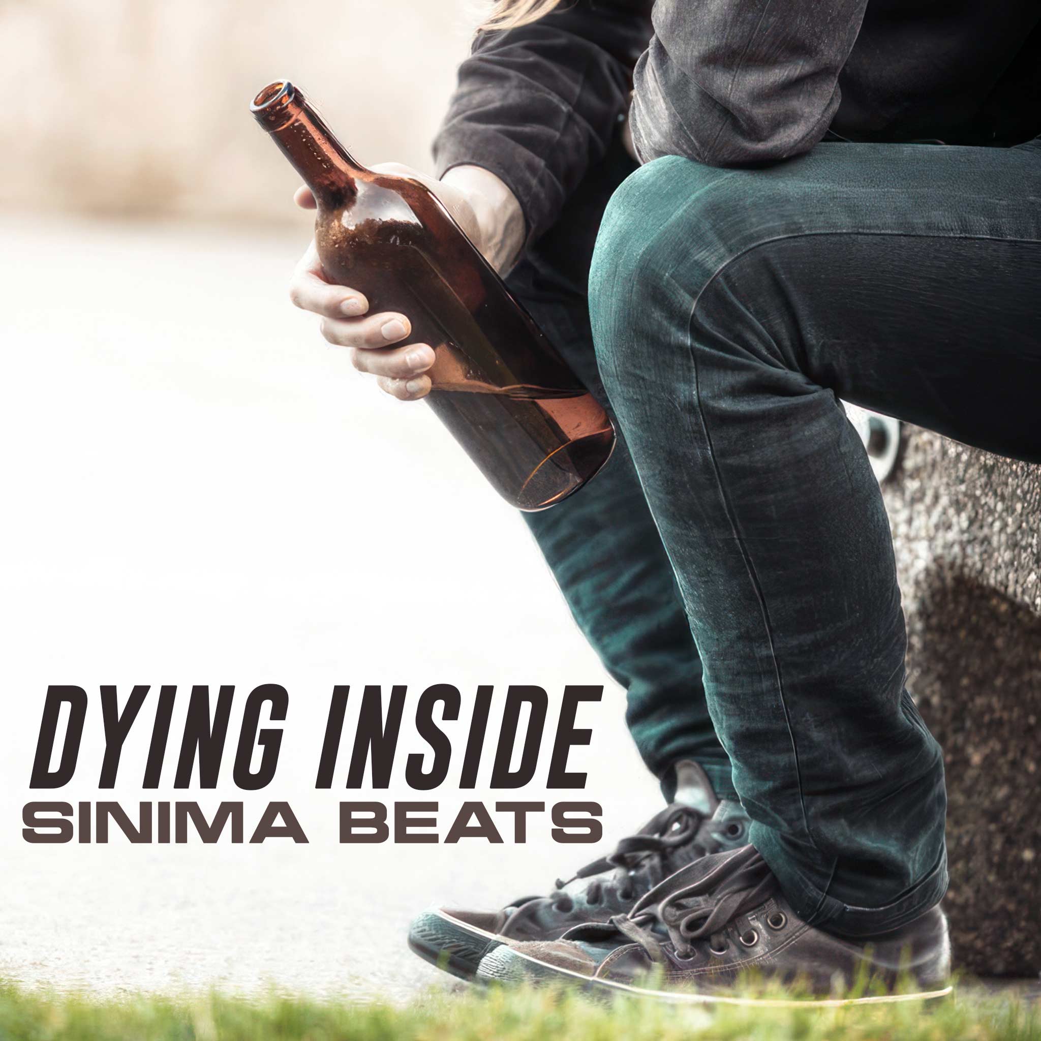 Dying Inside: A poignant scene of an alcoholic sitting outside with a bottle of beer, wearing jeans and sneakers. Captured through professional photography.