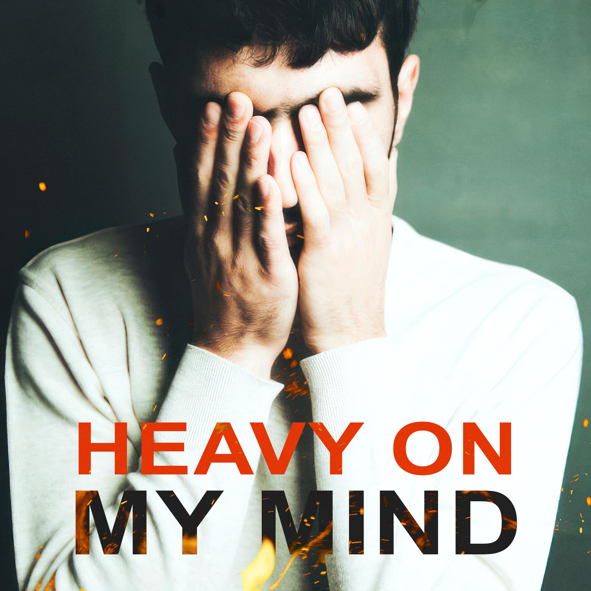 Man with Short Black Hair Wearing White Sweater, Covering Face with Hands, Against Green Background with Title Text, Flames, and Sparks - Heavy on My Mind