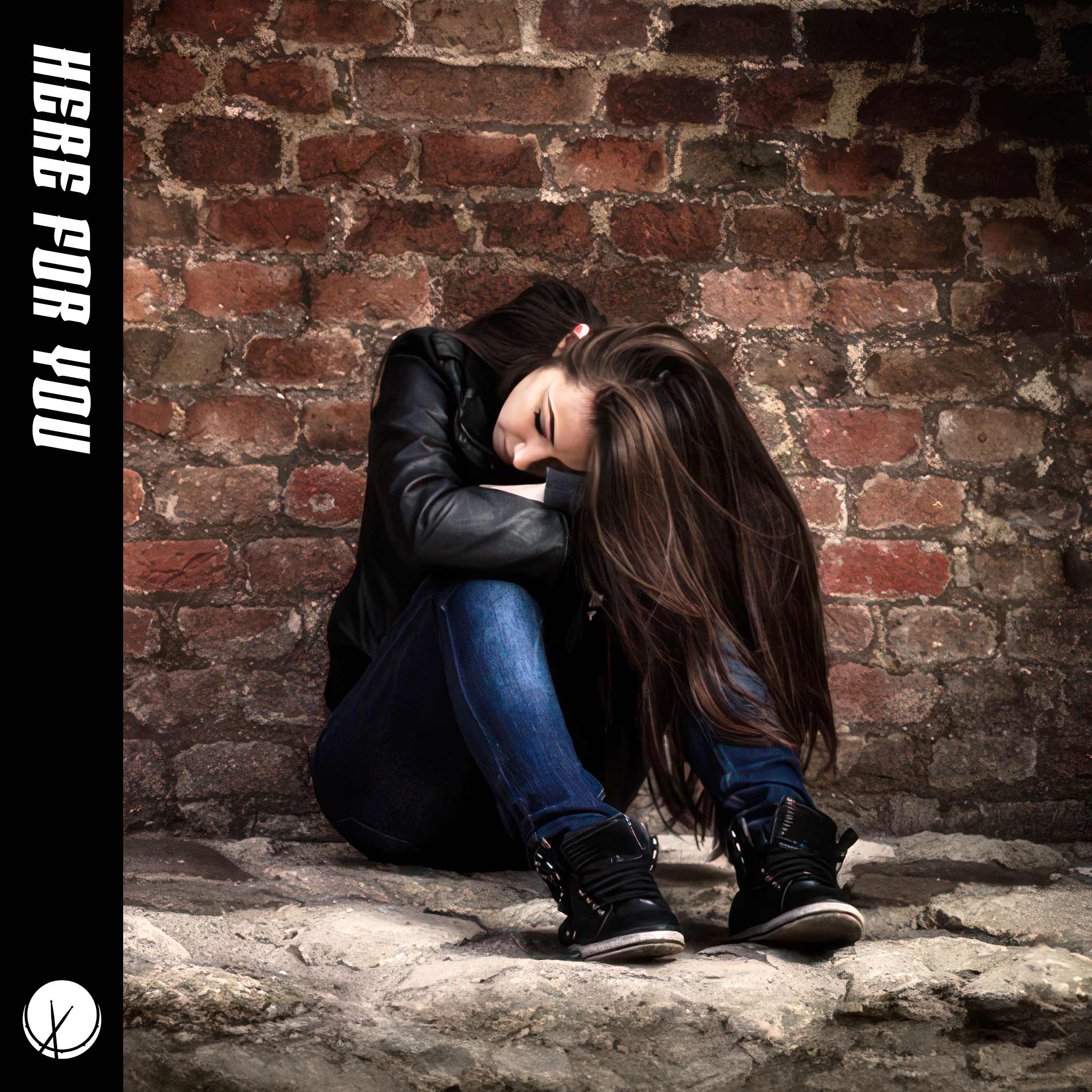 Young Girl with Brown Hair Sitting with Head Down, Wearing Blue Jeans, Black Sneakers, and Black Leather Jacket Against Brick Wall - Here for You