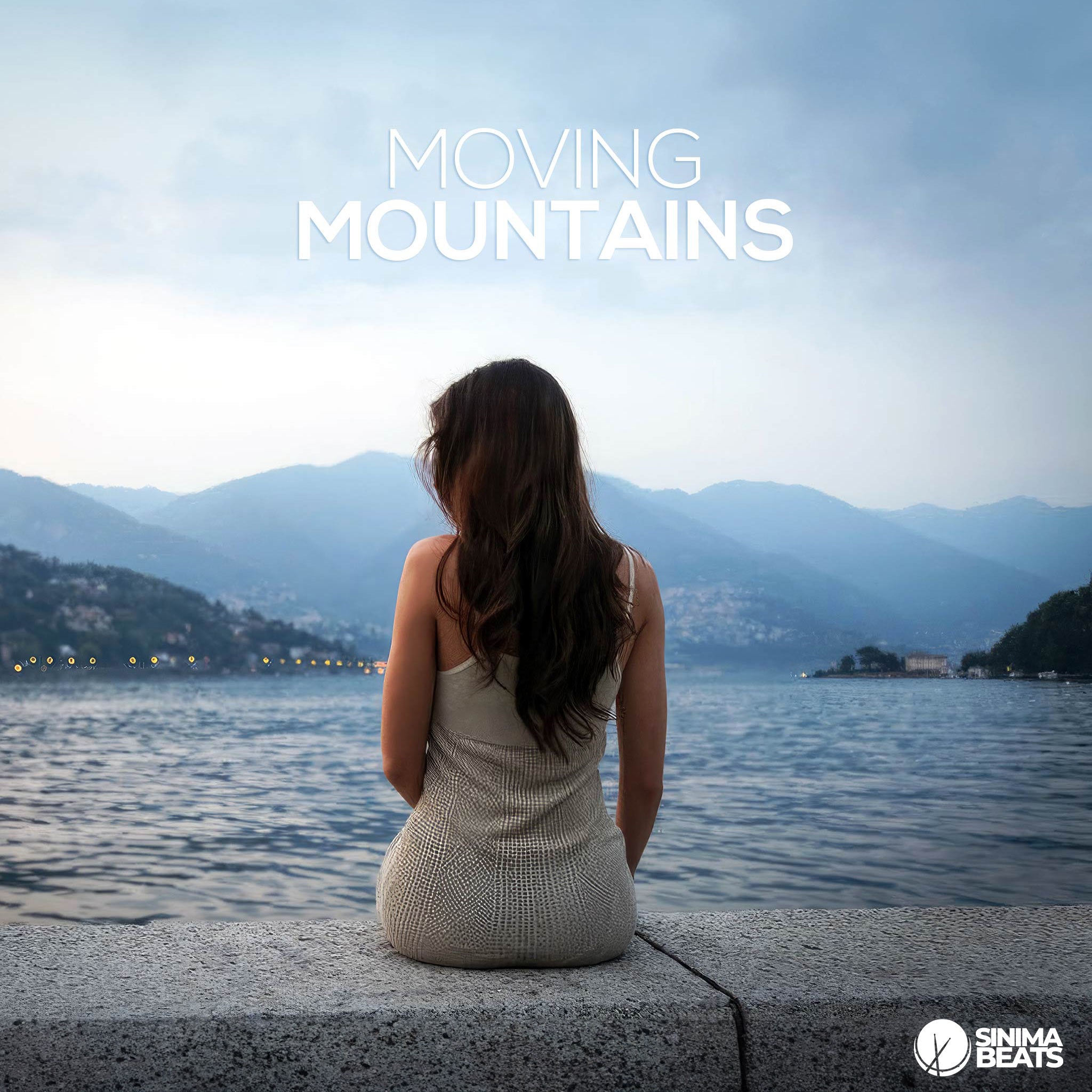 A serene and inspiring image showing a woman sitting by a lake, facing out towards a distant mountain range. The scene captures a sense of contemplation and connection with nature, emphasizing the theme of confidently overcoming challenges and achieving personal growth, reflecting the idea of "Moving Mountains."