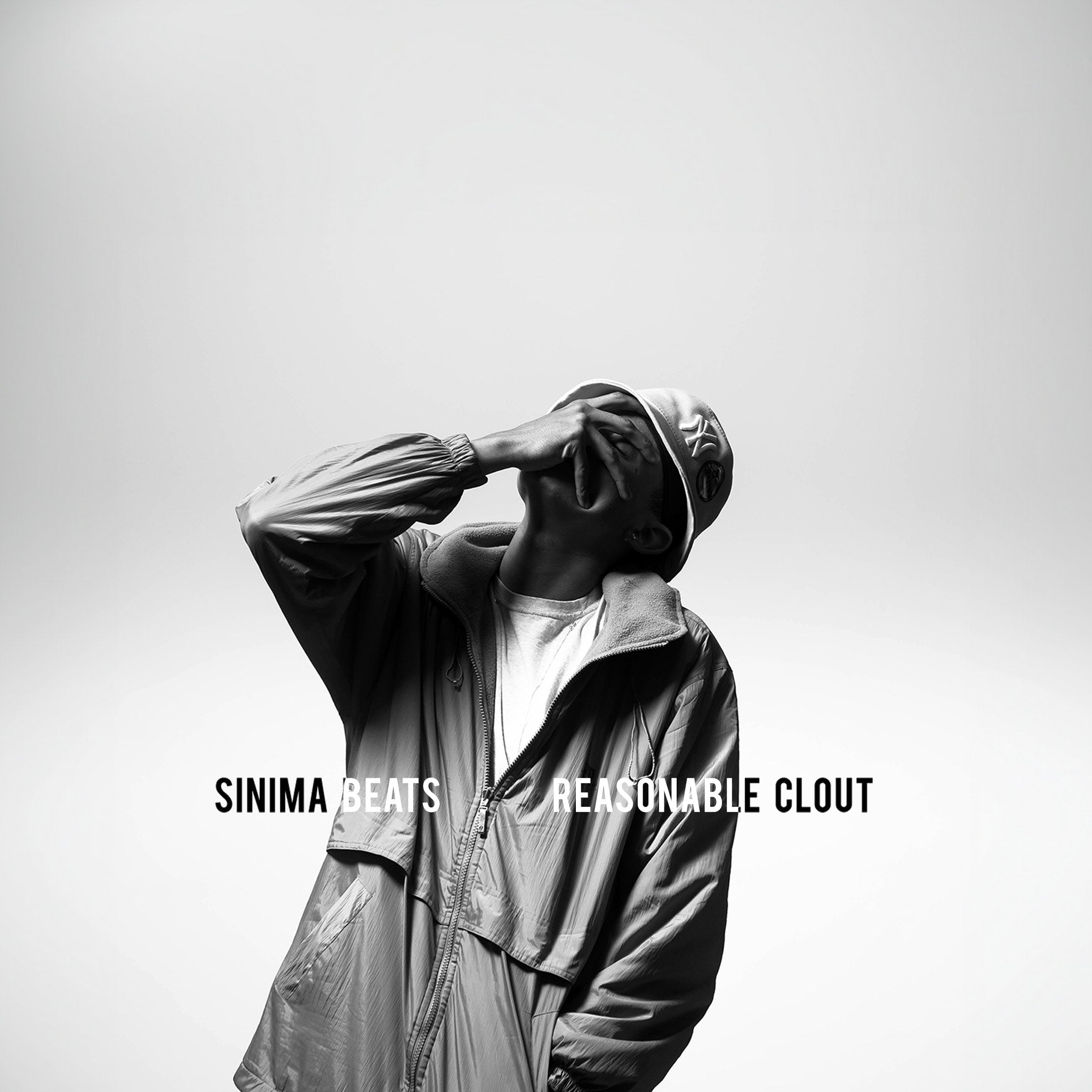 ‘Reasonable Clout’ features a rapper wearing an NY urban-style fisherman hat and jacket, pressing his hand against his own face in a gesture of disbelief. The grayscale image captures the raw emotion and street style that define the cover art.